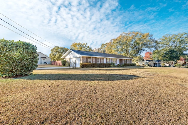 view of front of house with a garage and a front lawn