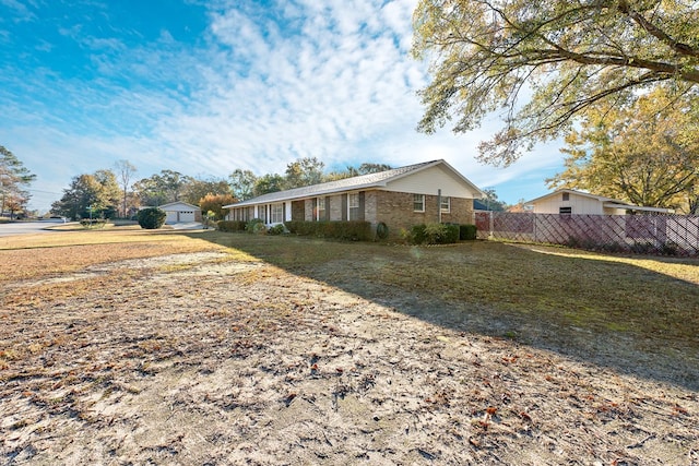 exterior space featuring brick siding and fence