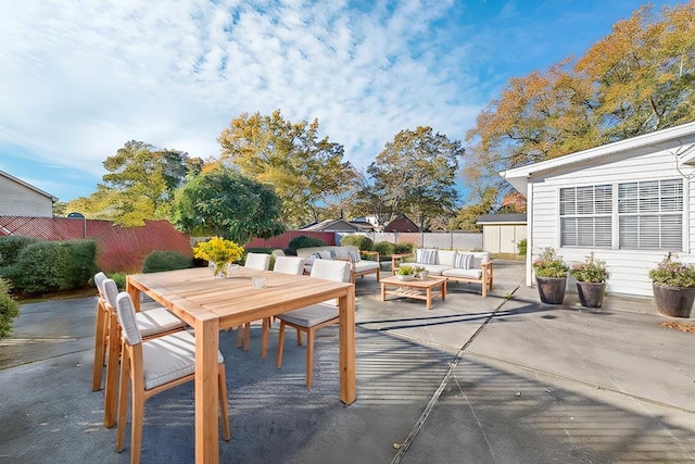 view of patio / terrace featuring outdoor dining space, a fenced backyard, and an outdoor hangout area