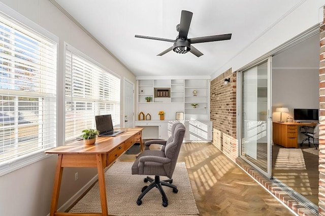 office featuring ornamental molding, a ceiling fan, and built in features