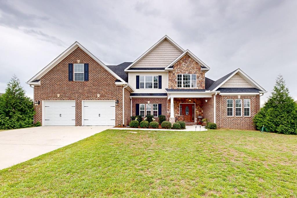 craftsman-style house featuring a front yard and a garage