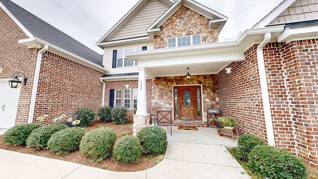 view of exterior entry featuring covered porch