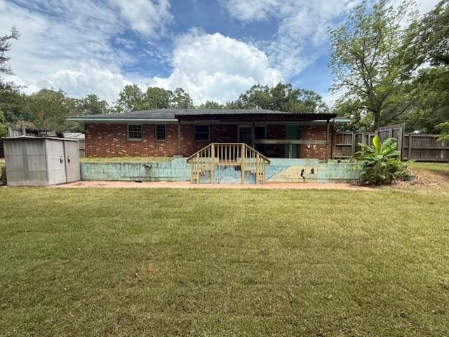 171 Merrydell Dr, Ozark, AL 36360 - back of house featuring a shed and brick siding