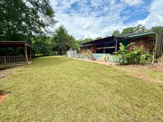 171 Merrydell Dr, Ozark, AL 36360 - view of green lawn featuring a storage shed and stairway