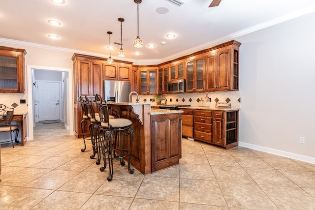 kitchen featuring stainless steel appliances, a kitchen bar, decorative backsplash, ornamental molding, and baseboards