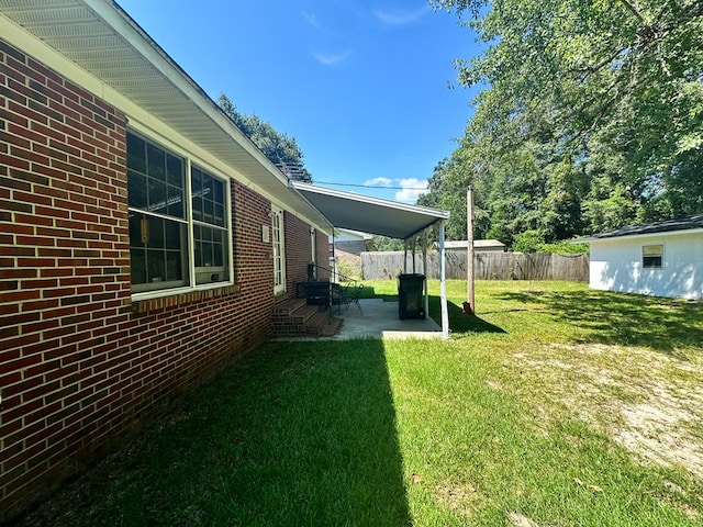 view of yard with entry steps, a patio area, and fence