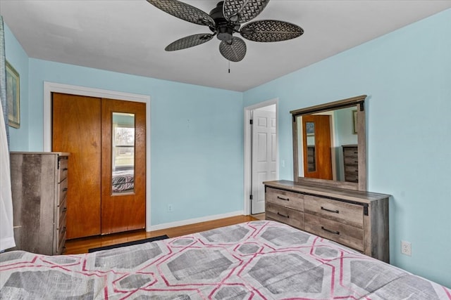 unfurnished bedroom featuring ceiling fan, wood finished floors, and baseboards