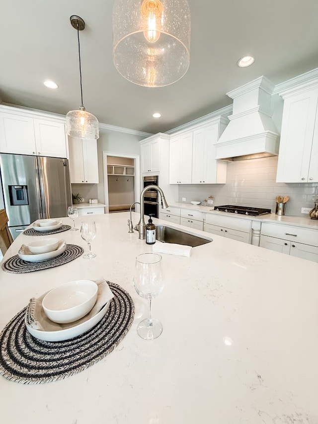 668 Charleston Mills Dr, Dothan, AL 36350 - kitchen featuring appliances with stainless steel finishes, custom exhaust hood, white cabinets, pendant lighting, and recessed lighting