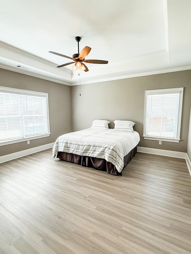 668 Charleston Mills Dr, Dothan, AL 36350 - bedroom featuring a raised ceiling, ornamental molding, light wood finished floors, and a ceiling fan
