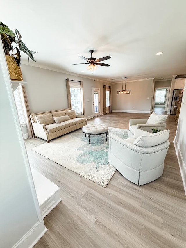 668 Charleston Mills Dr, Dothan, AL 36350 - living room featuring crown molding, healthy amount of natural light, light wood finished floors, ceiling fan, and recessed lighting