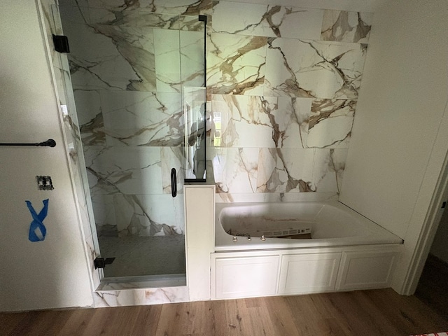 317 Old Village Rd, Ozark, AL 36360 - full bath with a marble finish shower, wood finished floors, and a garden tub