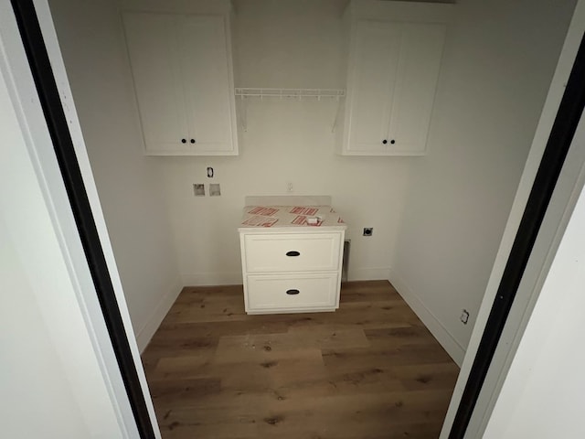 317 Old Village Rd, Ozark, AL 36360 - washroom with electric dryer hookup, light wood-style floors, and cabinet space