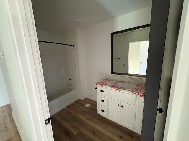 317 Old Village Rd, Ozark, AL 36360 - full bath with vanity, wood finished floors, and bathing tub / shower combination