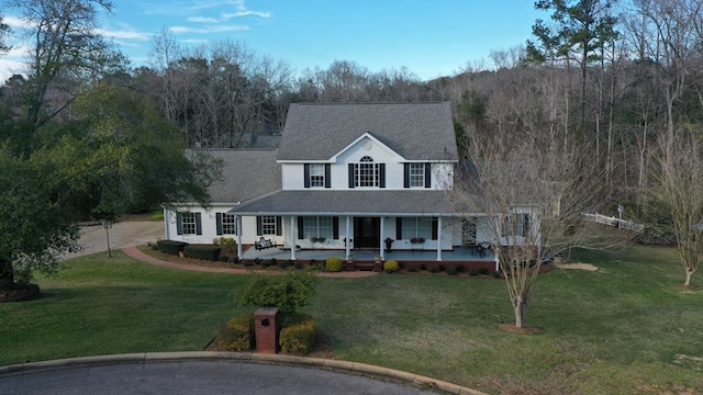 view of front of property featuring a front lawn, a porch, driveway, and a shingled roof