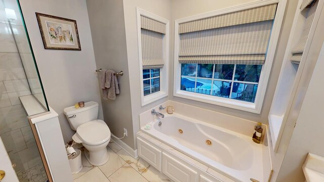 full bathroom with tiled shower, toilet, baseboards, and a whirlpool tub