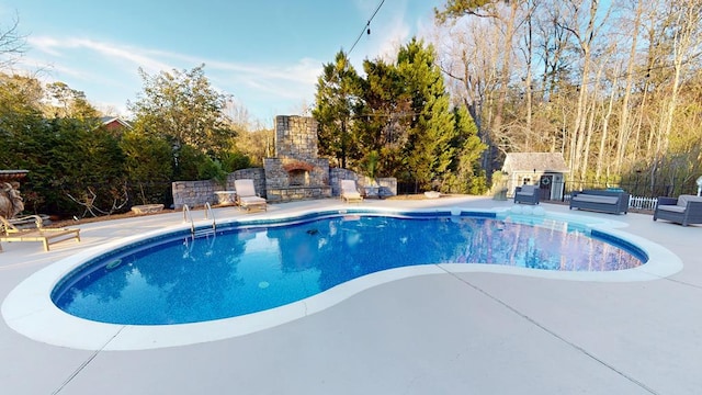 view of pool featuring an outdoor living space with a fireplace, a patio, and fence