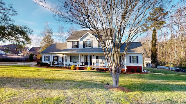 traditional-style house featuring covered porch and a front lawn