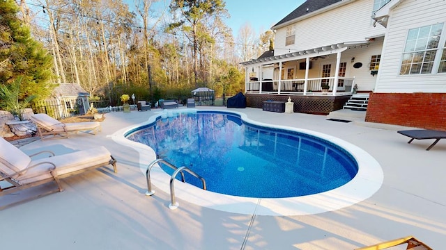 view of pool featuring a pergola, a fenced in pool, a wooden deck, and fence