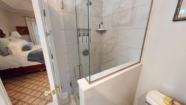 ensuite bathroom featuring toilet, a shower stall, ornamental molding, and connected bathroom