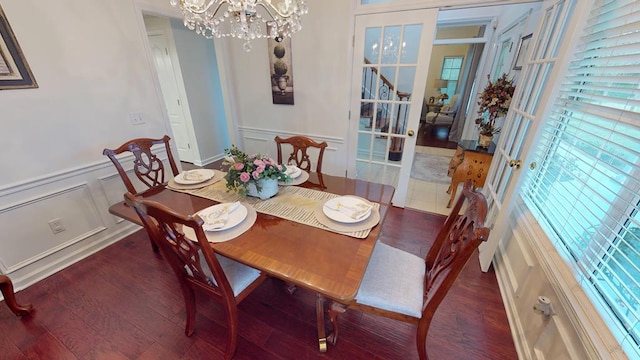 dining space with wood finished floors, a chandelier, and a healthy amount of sunlight