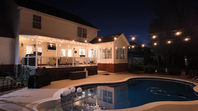 pool with a patio and a deck