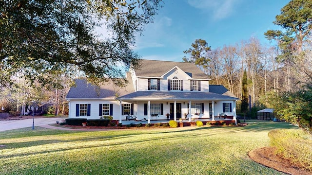 view of front of home with a front yard and covered porch