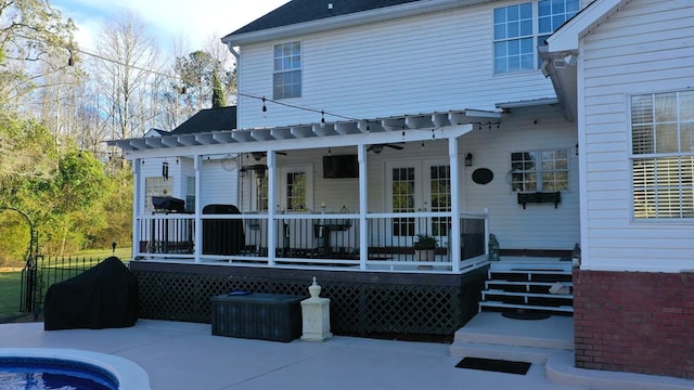 rear view of house featuring french doors, a wooden deck, a ceiling fan, and fence