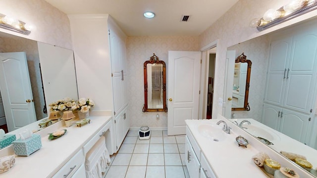 bathroom with visible vents, vanity, tile patterned flooring, and wallpapered walls