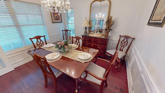 dining area with an inviting chandelier, wood finished floors, wainscoting, and a decorative wall