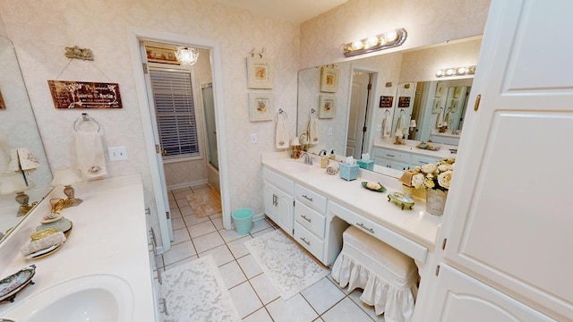 full bathroom with two vanities, a shower with door, a sink, wallpapered walls, and tile patterned flooring