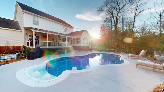 outdoor pool with a patio and fence