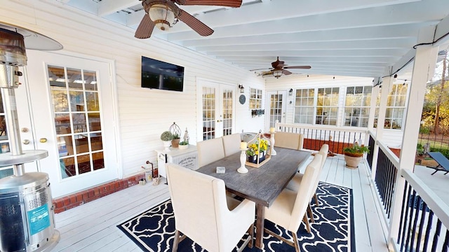 sunroom / solarium with lofted ceiling with beams and ceiling fan