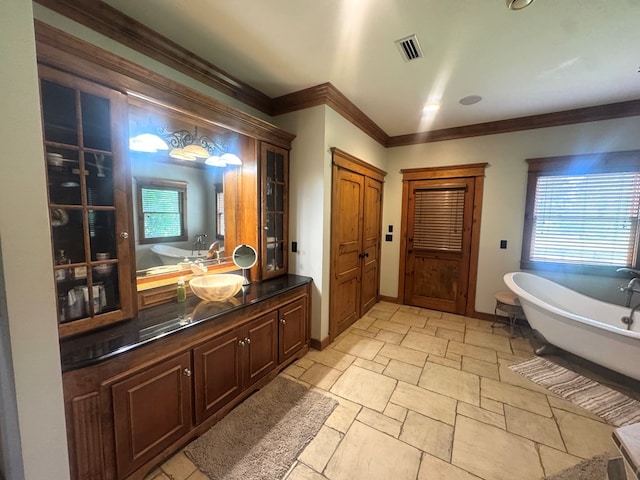 2837 Woodham Rd, Dothan, AL 36303 - bathroom featuring a soaking tub, ornamental molding, vanity, and stone tile floors