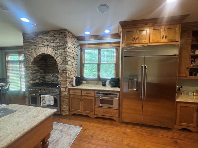 2837 Woodham Rd, Dothan, AL 36303 - kitchen featuring premium appliances, brown cabinets, light wood finished floors, and recessed lighting