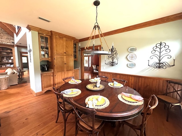 2837 Woodham Rd, Dothan, AL 36303 - dining space featuring light wood-style flooring, a wainscoted wall, and ornamental molding