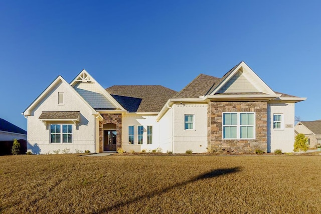 500 Charleston Mills Dr, Dothan, AL 36350 - view of front of property with stone siding, a shingled roof, and a front yard