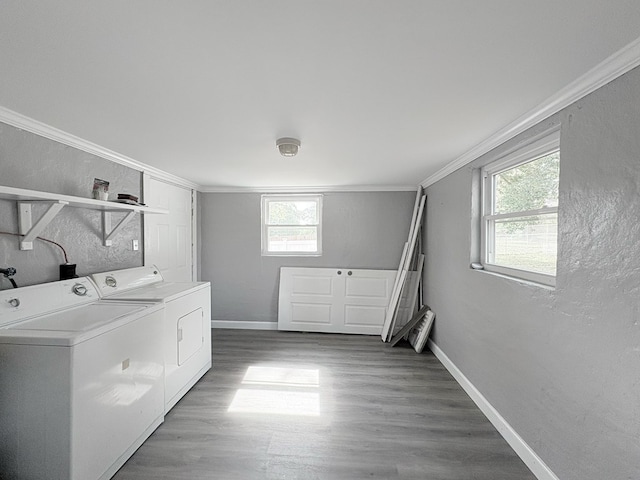 laundry room featuring washer and clothes dryer, crown molding, and hardwood / wood-style floors