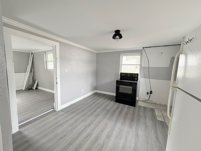 kitchen featuring ornamental molding, black electric range oven, white refrigerator, and light wood-type flooring