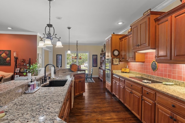 206 N Main St, Columbia, AL 36319 - kitchen with sink, ornamental molding, pendant lighting, black electric stovetop, and light stone countertops