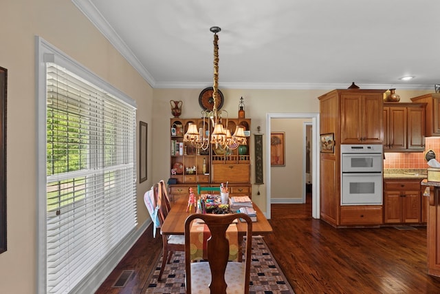 206 N Main St, Columbia, AL 36319 - dining space with dark hardwood / wood-style flooring, ornamental molding, and a chandelier