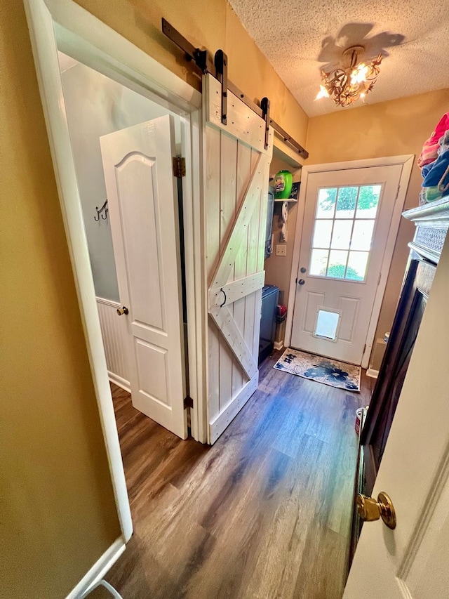 1503 Buena Vista Dr, Dothan, AL 36303 - doorway featuring a barn door, wood finished floors, and a textured ceiling