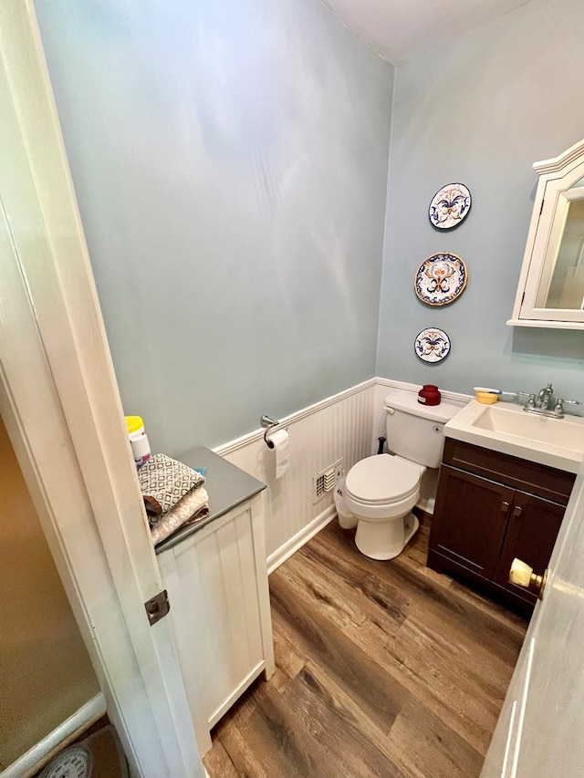 1503 Buena Vista Dr, Dothan, AL 36303 - half bathroom with a wainscoted wall, wood finished floors, toilet, and vanity