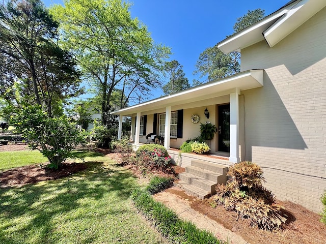 1503 Buena Vista Dr, Dothan, AL 36303 - entrance to property with brick siding, a porch, and a yard