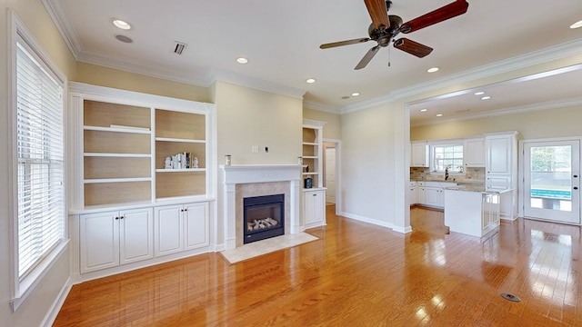107 Boulder Dr, Dothan, AL 36305 - unfurnished living room with baseboards, light wood finished floors, a fireplace with flush hearth, a ceiling fan, and recessed lighting