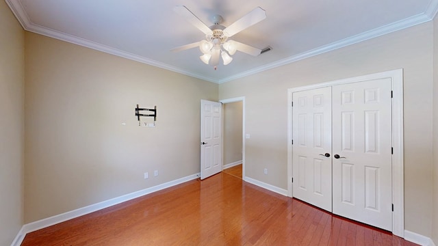107 Boulder Dr, Dothan, AL 36305 - unfurnished bedroom featuring crown molding, light wood-style flooring, baseboards, a closet, and ceiling fan