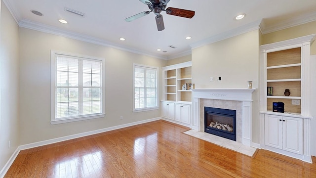 107 Boulder Dr, Dothan, AL 36305 - unfurnished living room with a tile fireplace, ceiling fan, light wood-style floors, baseboards, and ornamental molding