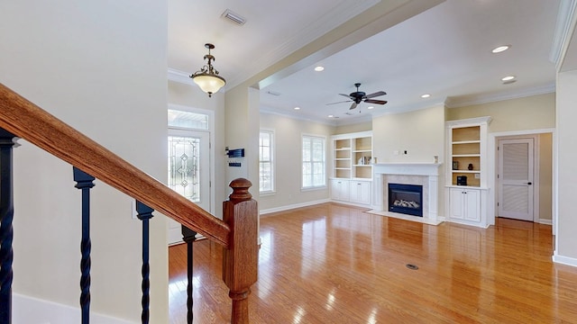 107 Boulder Dr, Dothan, AL 36305 - unfurnished living room featuring crown molding, light wood-type flooring, a fireplace with flush hearth, recessed lighting, and a ceiling fan