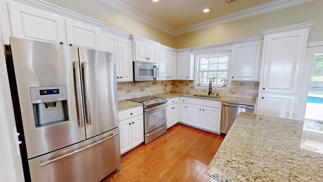 107 Boulder Dr, Dothan, AL 36305 - kitchen with stainless steel appliances, a sink, healthy amount of natural light, white cabinetry, and crown molding