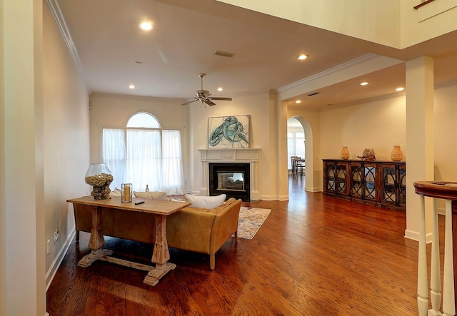 221 Asphodel Dr, Dothan, AL 36303 - living room with crown molding, arched walkways, wood finished floors, a fireplace, and ceiling fan
