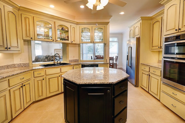 221 Asphodel Dr, Dothan, AL 36303 - kitchen with stainless steel appliances, ceiling fan, dark cabinetry, glass insert cabinets, and a center island